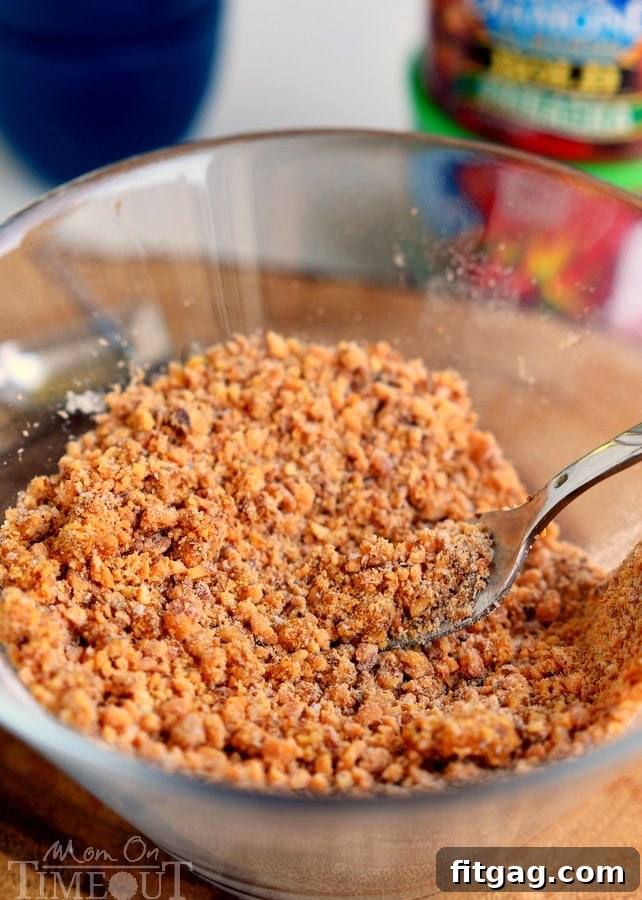 Flour, garlic powder, salt, and pepper mixed with finely chopped Sriracha almonds in a clear bowl