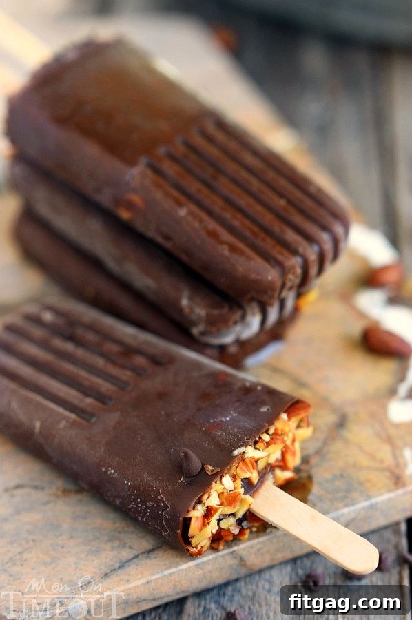 Three Mocha Almond Fudge Pudding Pops standing upright, showcasing their delicious texture