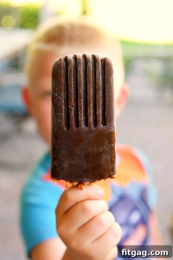 Mocha Almond Fudge Pudding Pops on a rustic wooden board, ready for tasting