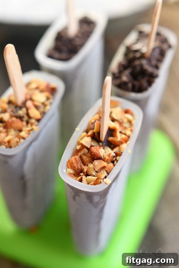 Pudding pops being poured into molds with a funnel, showcasing the easy process