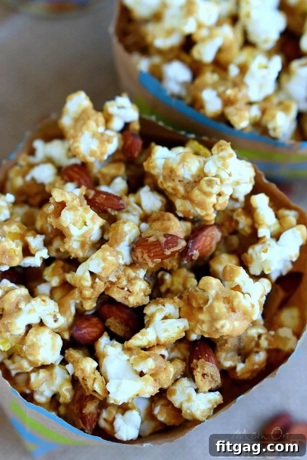 Sweet & Salty Almond Popcorn Crunch 4 Close-up of a bowl of Salted Caramel Popcorn with Almonds, inviting and delicious. | MomOnTimeout.com
