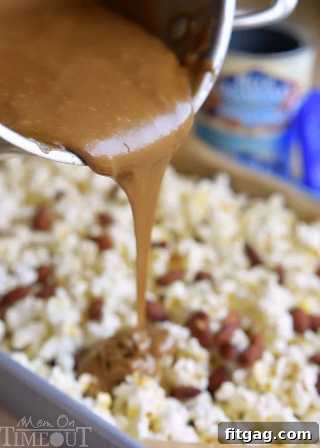 Sweet & Salty Almond Popcorn Crunch 6 Close-up of a handful of Salted Caramel Popcorn with Almonds, showing the crunchy texture and rich caramel coating.