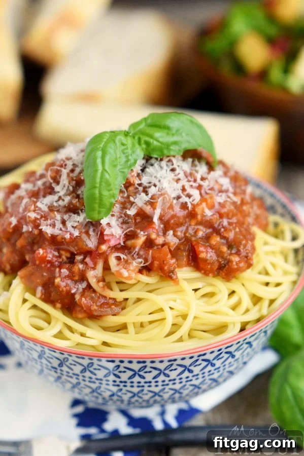 This easy homemade Spaghetti Sauce recipe is perfect for busy weeknights! Made in the slow cooker, this delicious spaghetti sauce is full of flavor and makes a large batch which is great for freezing. Enjoy with your family tonight! Make it with or without meat - your choice! // Mom On Timeout #spaghetti #sauce #recipe #dinner #easy #recipes #slowcooker #crockpot How to make slow cooker spaghetti sauce