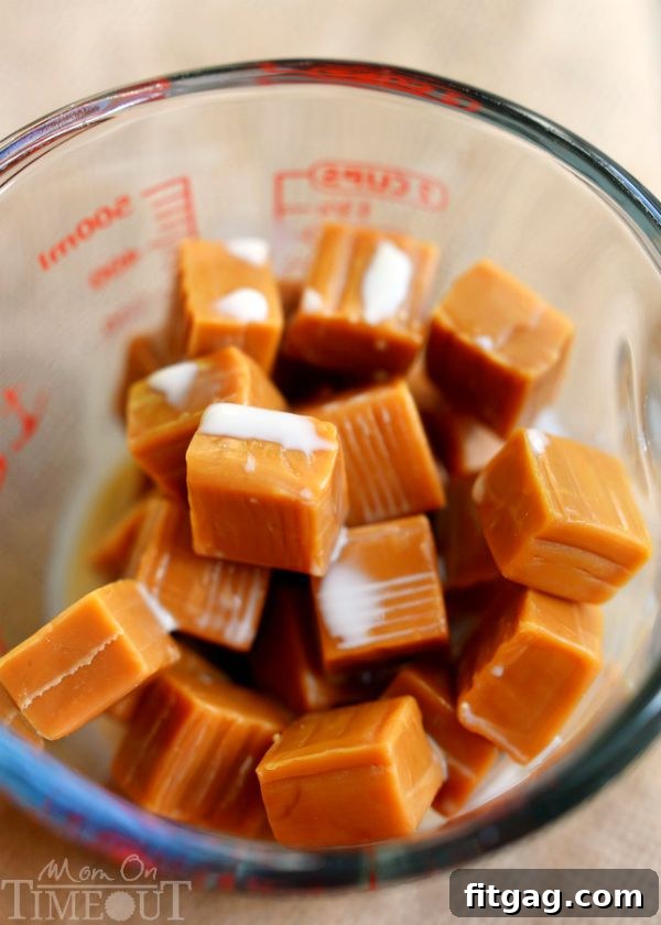 Caramels and evaporated milk melting in a Pyrex measuring cup