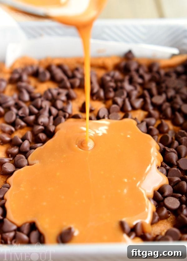 Pouring melted caramel over a layer of chocolate chips