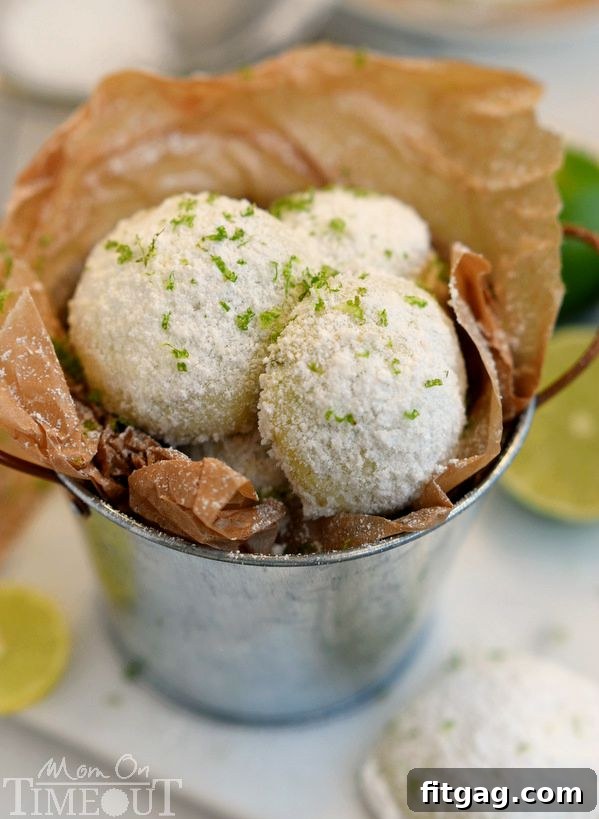 Zesty Key Lime Meltaways 3 Homemade Key Lime Snowball Cookies, dusted with powdered sugar, showcasing their simple yet delicious charm. Made with just five ingredients for an easy dessert.
