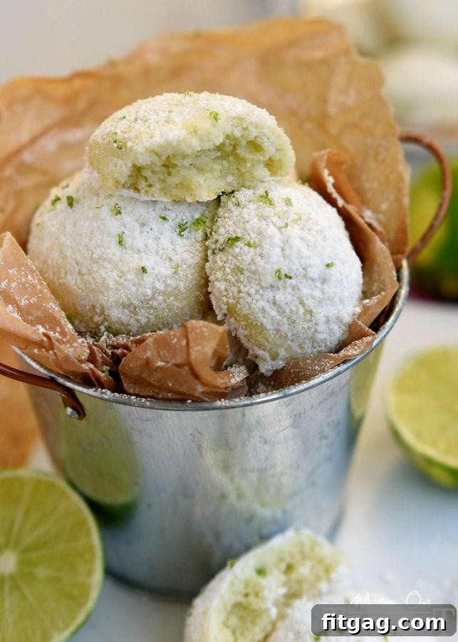 Zesty Key Lime Meltaways 5 A close-up of a Key Lime Snowball Cookie, showing off its powdered sugar coating, inviting you to take a bite.