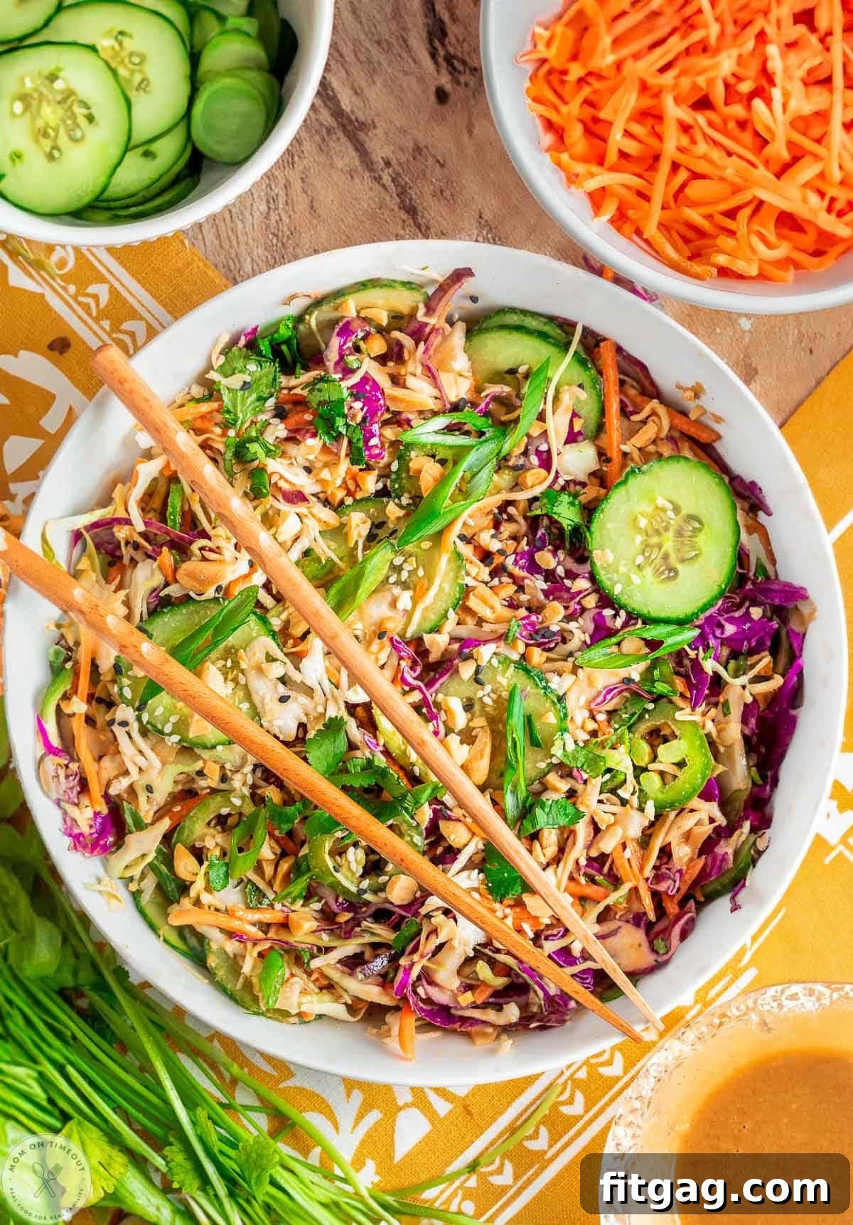 Thai Peanut Salad with Crunchy Veggies and Lime Dressing 2 Overhead shot of large white bowl with summer thai salad that has been tossed with peanut dressing. Two chopsticks are laid on top of the bowl.