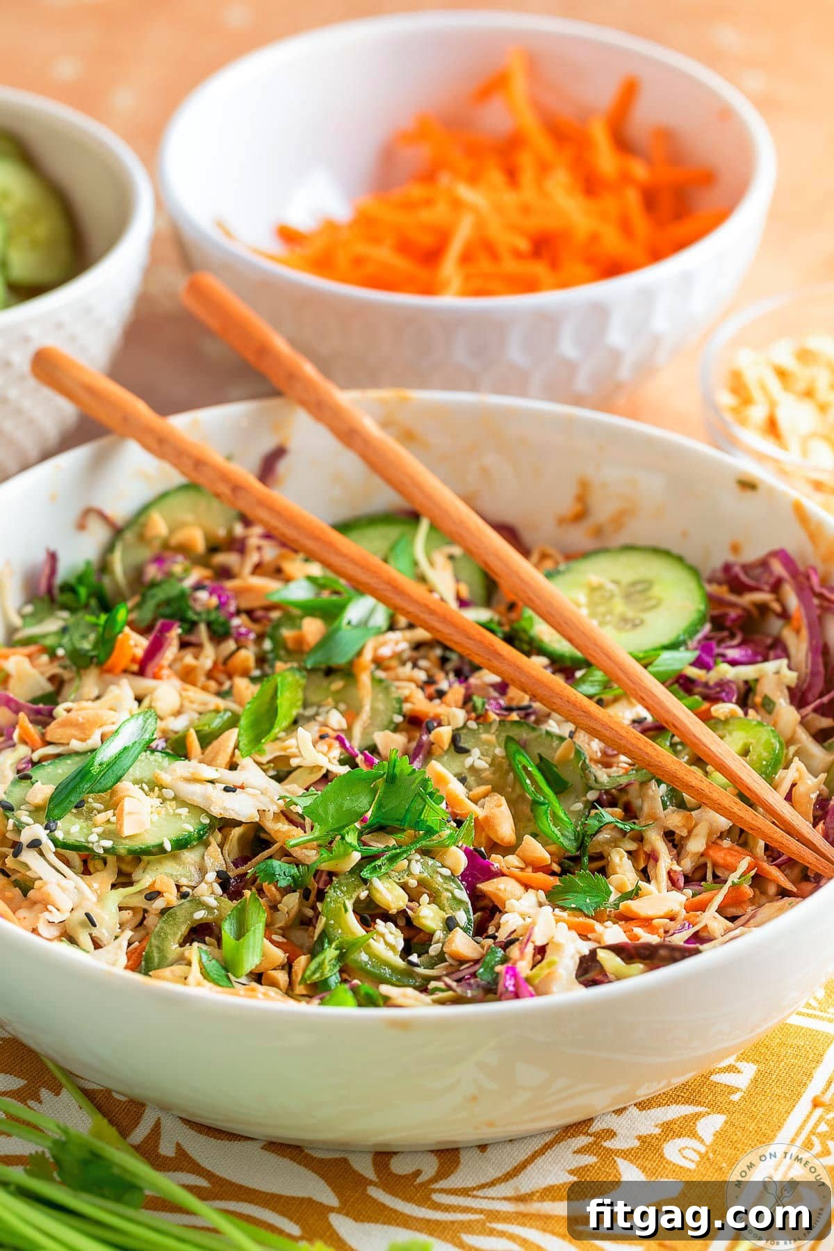 Thai Peanut Salad with Crunchy Veggies and Lime Dressing 3 Shot of low white bowl with Thai salad recipe with peanut dressing missed together.