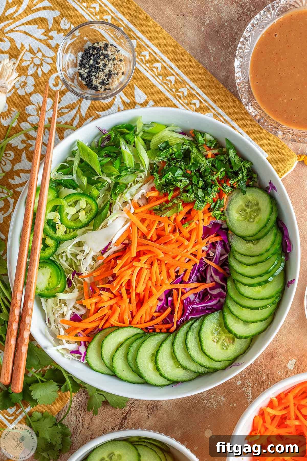 Thai Peanut Salad with Crunchy Veggies and Lime Dressing 7 Thai salad ingredients laid out in white bowl.